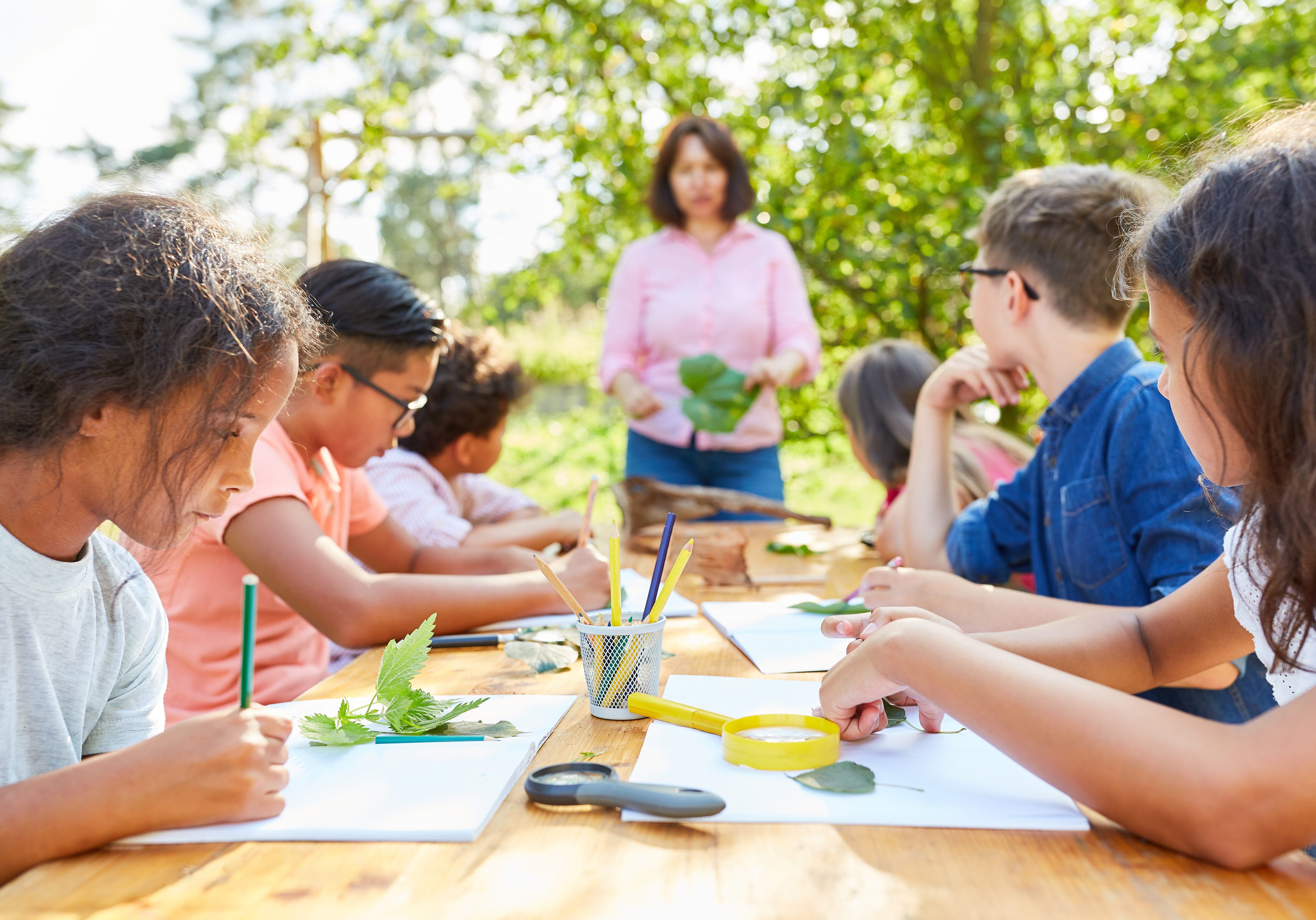 Children do handicrafts and draw plants in creative art class at summer camp